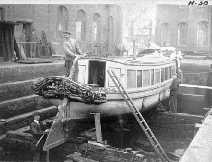 Black and white photograph depicting The Earl of Ellesmere’s barge in dry dock, c1920s (Peel Archives: Bridgewater Canal Collection)